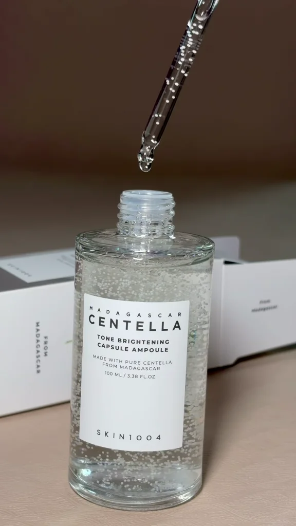Close-up of Sofiya applying SKIN1004 Centella Tone Brightening Capsule Ampoule