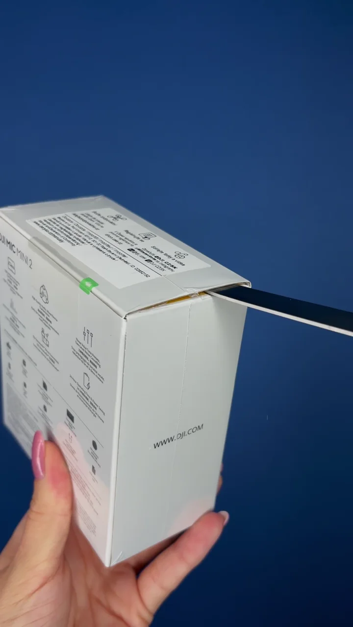 DJI Mic Mini creator microphone kit unboxed against a blue background