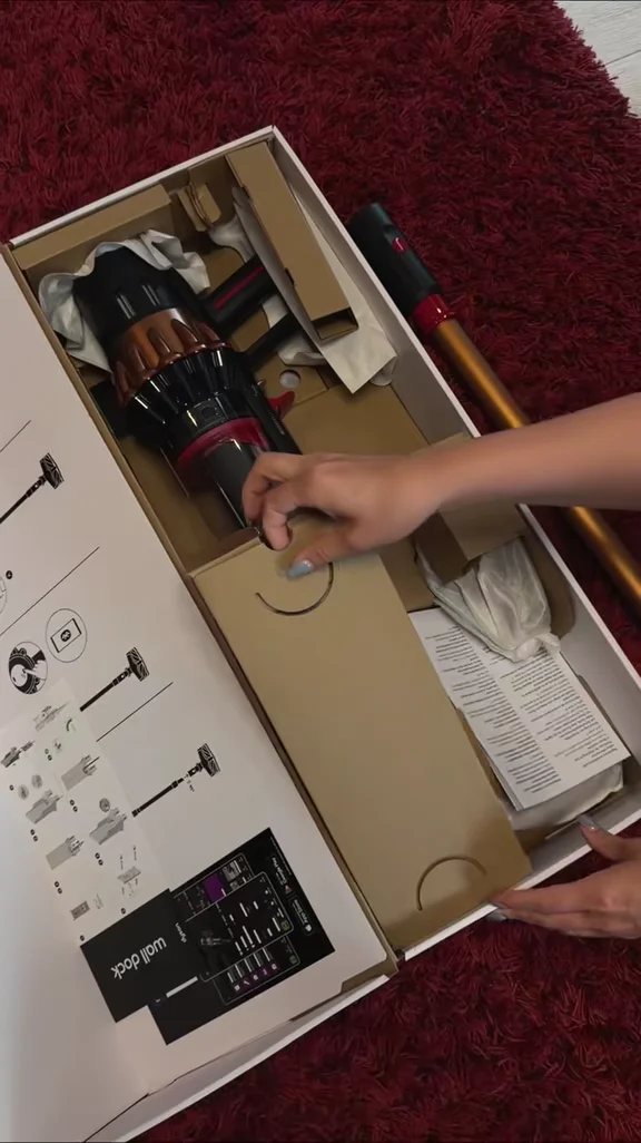 Sofiya unboxing a Dyson hair tool and showing its attachments