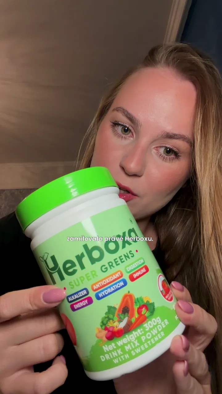 Sofiya holding Herboxa Greens powder and a branded shaker